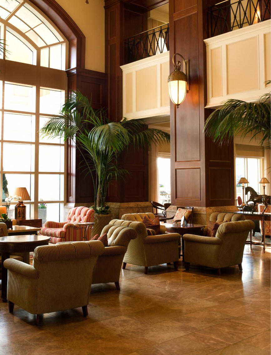 A warmly lit hotel lobby with seating ready for guests