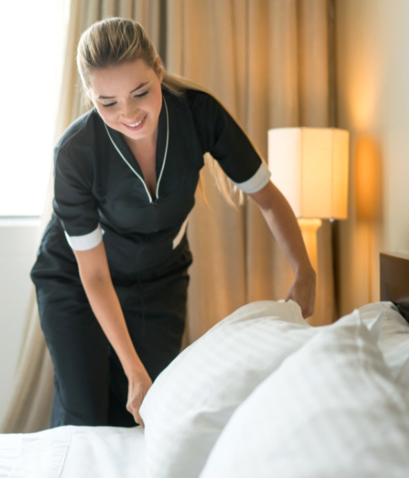 Housekeeping professional preparing a guest room